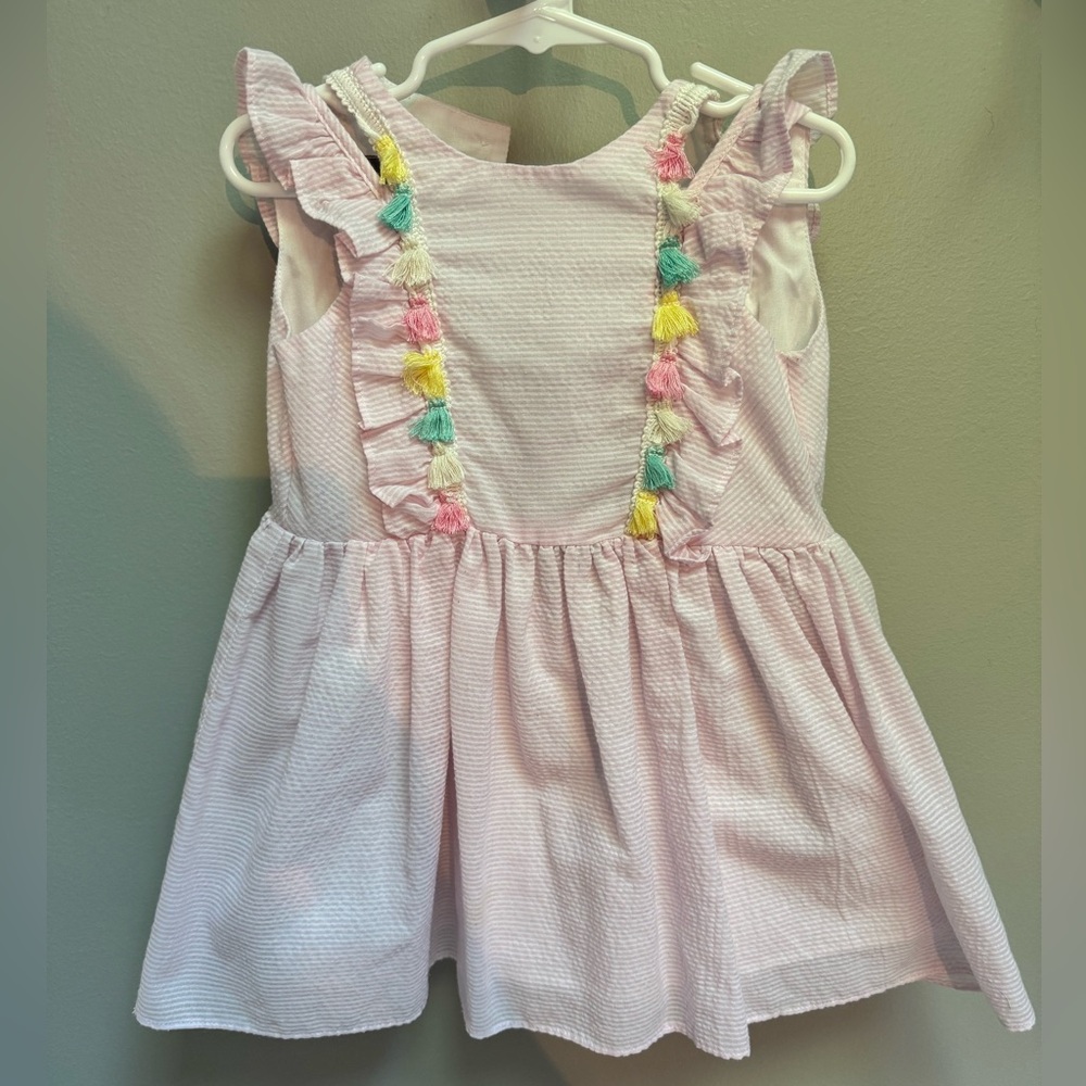 Pink seersucker dress with tassels. So feminine and adorable!